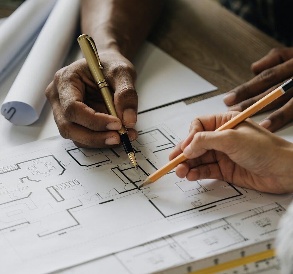 Team construction engineers working at construction site with blueprint on table